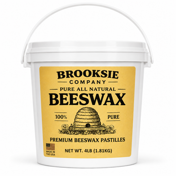 A white plastic bucket of Brooksie Company Pure All Natural Beeswax pastilles, featuring a large yellow label with black text and an illustration of a beehive.