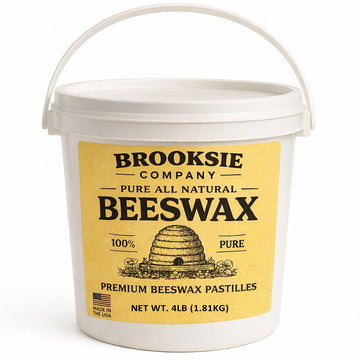 White bucket of Brooksie Company pure all natural beeswax on a white background